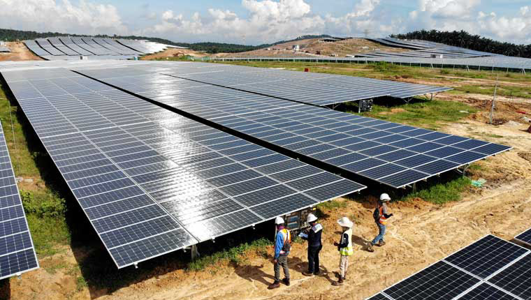 A panoramic view of the Tenaga Nasional Solar Farm in Bukit Selambau, Malaysia, with rows of solar panels harnessing sunlight for clean energy production